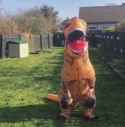 Чудачка использует полученный в подарок костюм динозавра, чтобы подбодрить соседей